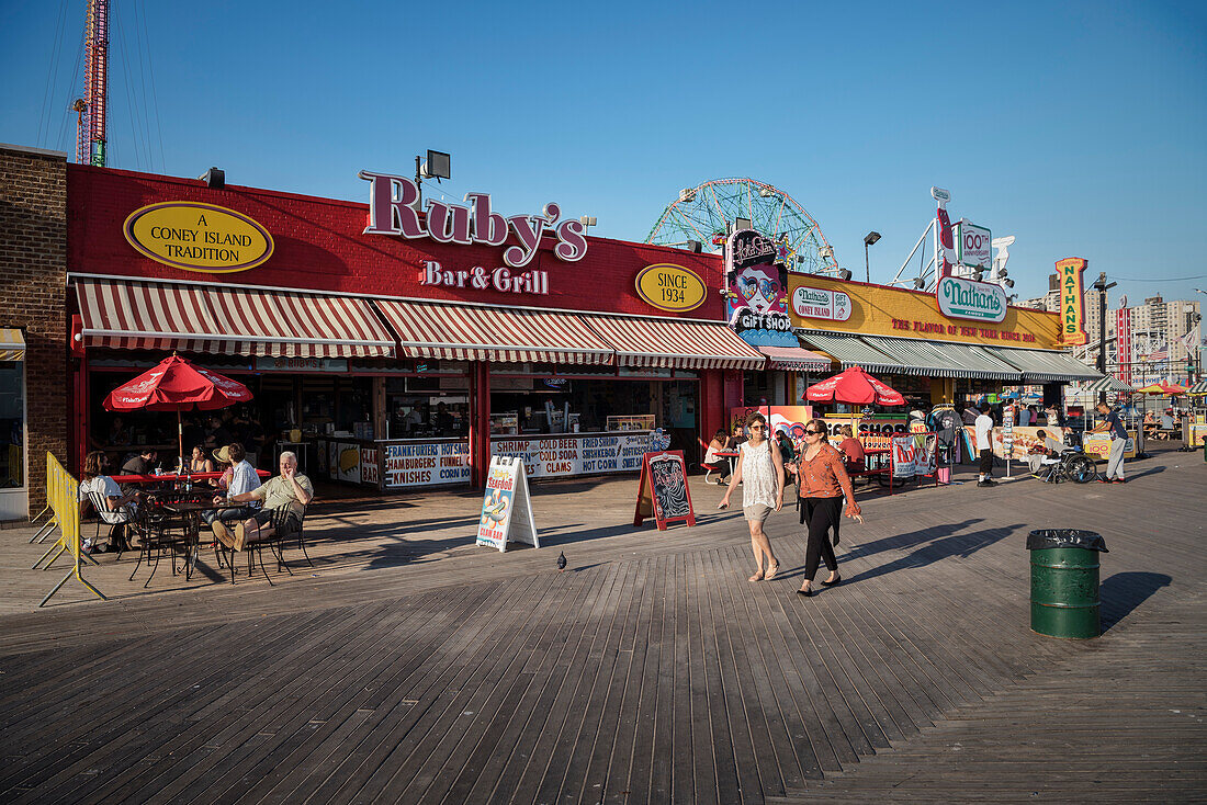 people on Riegelmann Boardwalk in front of Ruby’s Bar & Grill, Coney Island, Brooklyn, NYC, New York City, United States of America, USA, North America