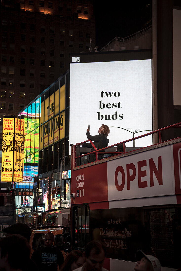 woman on a double decker tourist bus taking a photo of Times Square, Manhattan, NYC, New York City, United States of America, USA, North America