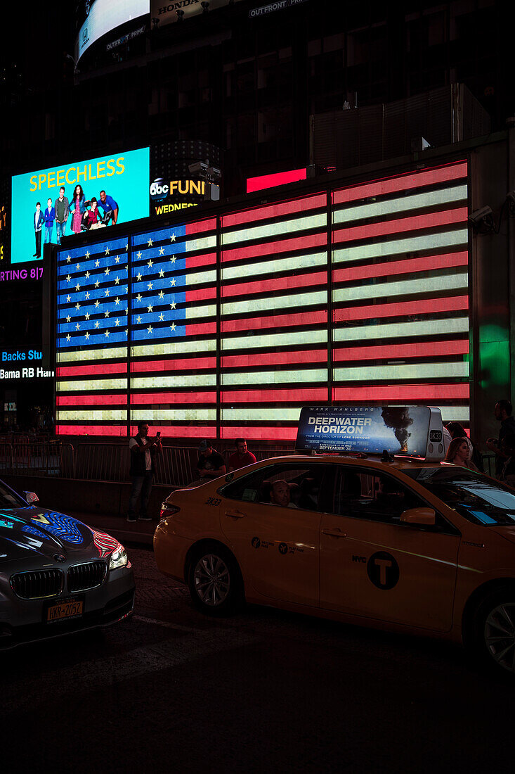 Illuminated US flag at Times Square of US Army Recruiting building, Manhattan, NYC, New York City, United States of America, USA, North America