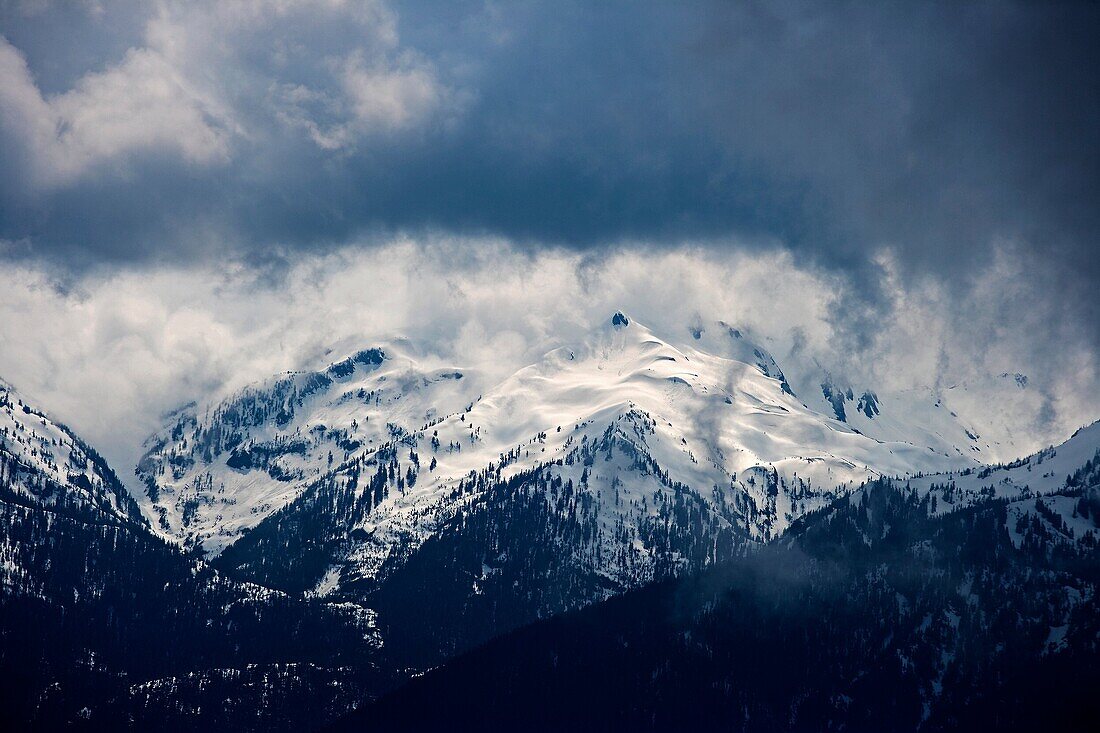 Snow storm moving in on the snow capped Olympic Mountains in the U.S.