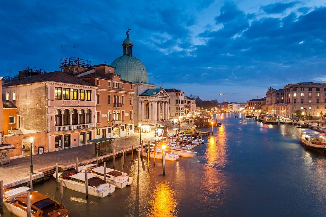 Night falls on Grand Canal in Venice, Italy. San Simeone Piccolo church dome towers above Santa Croce district.