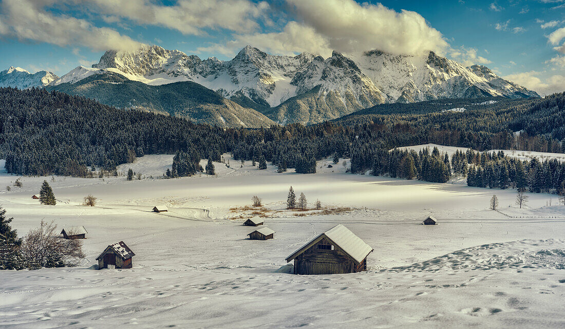 View over snow-covered huts on the frozen Geroldsee and Karwendel mountains, Gerold, Upper Bavaria, Germany
