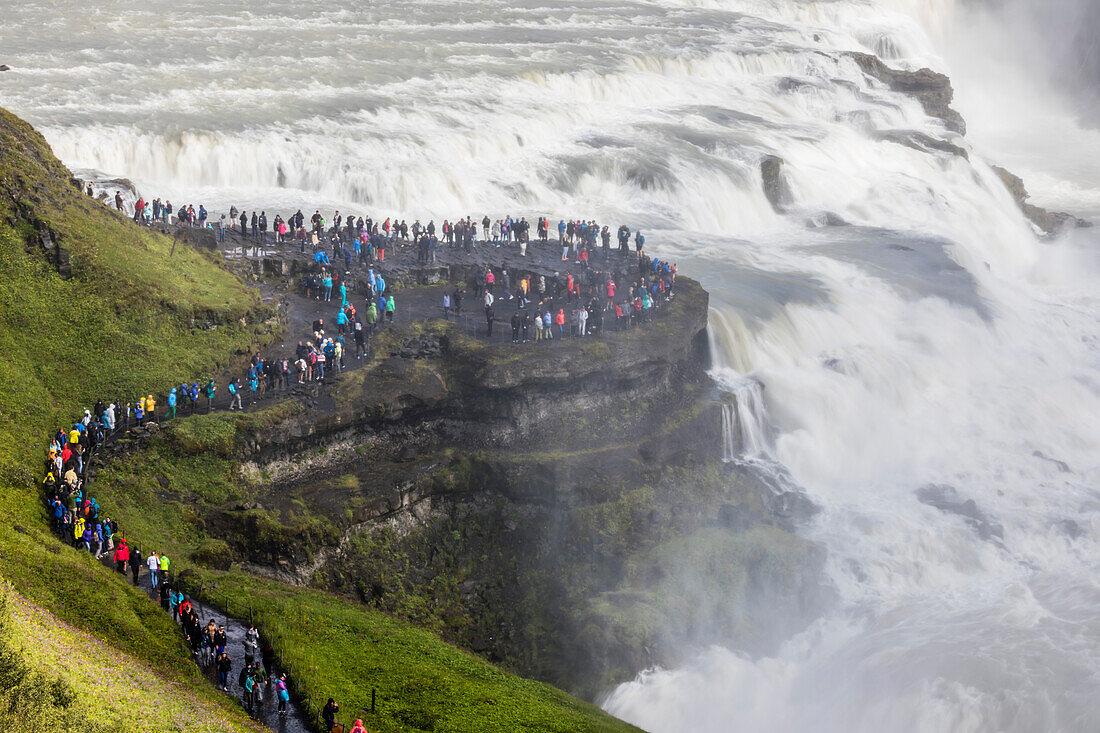 Tourists visiting iconic Gullfoss (Golden Falls), Olfusa River in southwest Iceland, Polar Regions