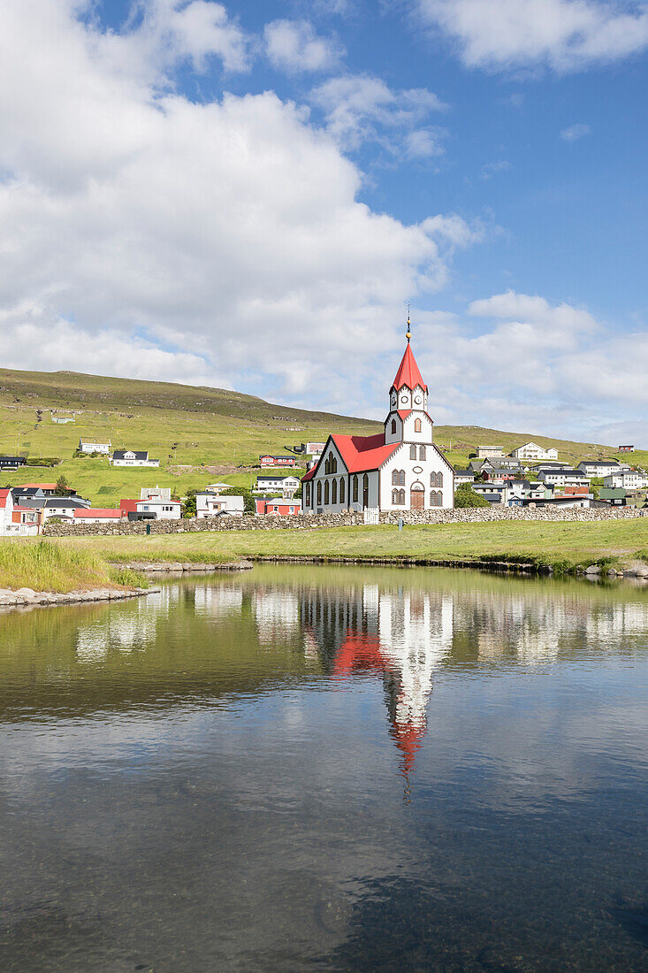 Church of Sandavagur reflected in water, Vagar Island, Faroe Islands, Denmark, Europe
