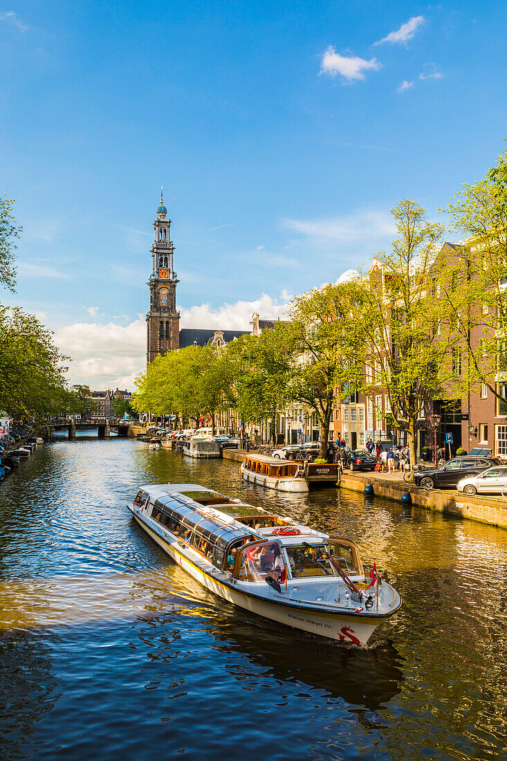 Boat on Prinsengracht Canal, with Westerkerk in the background, Amsterdam, Netherlands, Europe