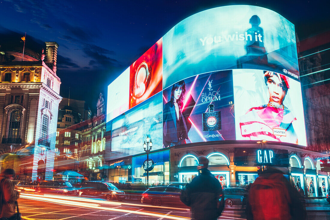 Traffic trails and advertisements at night near Piccadilly Circus, London, England, United Kingdom, Europe