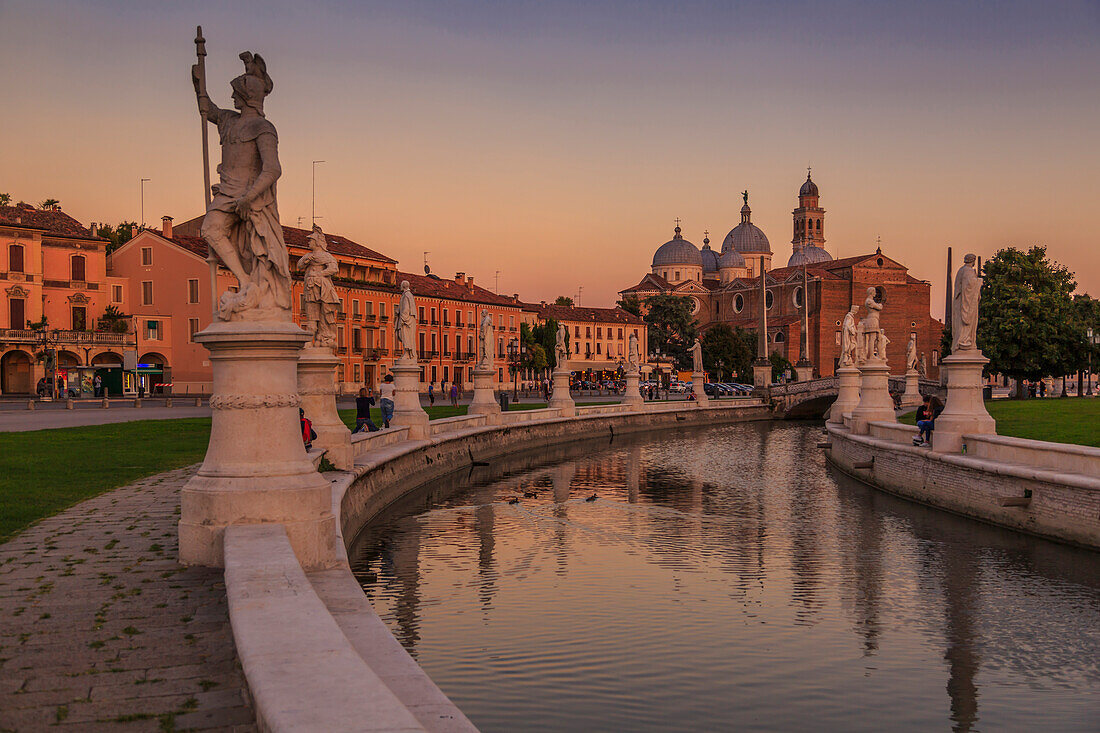 View of statues in Prato della Valle at dusk and Santa Giustina Basilica visible in background, Padua, Veneto, Italy, Europe