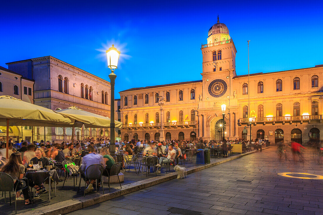 View of cafes and Torre Dell'Orologio in Piazza dei Signori at dusk, Padua, Veneto, Italy, Europe