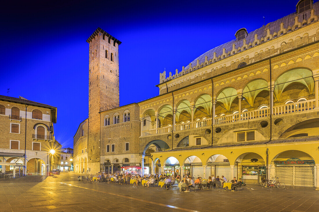 Cafes and Tower of Anziani in Piazza della Frutta at dusk, Ragione Palace is visible, Padua, Veneto, Italy, Europe