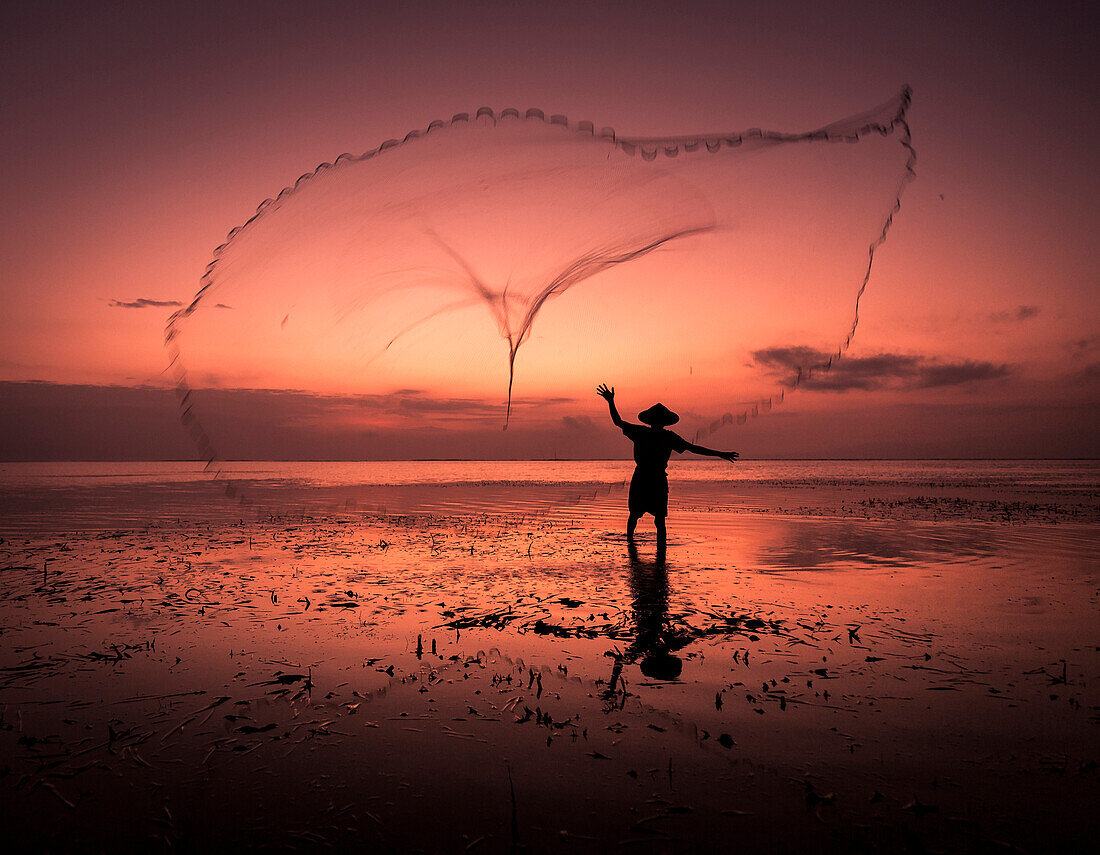 Sunrise fisherman casting his net, Bali, Indonesia, Southeast Asia, Asia