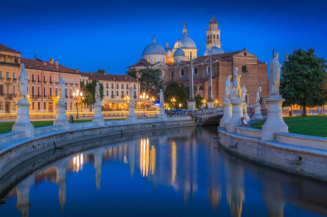 View of statues in Prato della Valle at dusk and Santa Giustina Basilica visible in background, Padua, Veneto, Italy, Europe