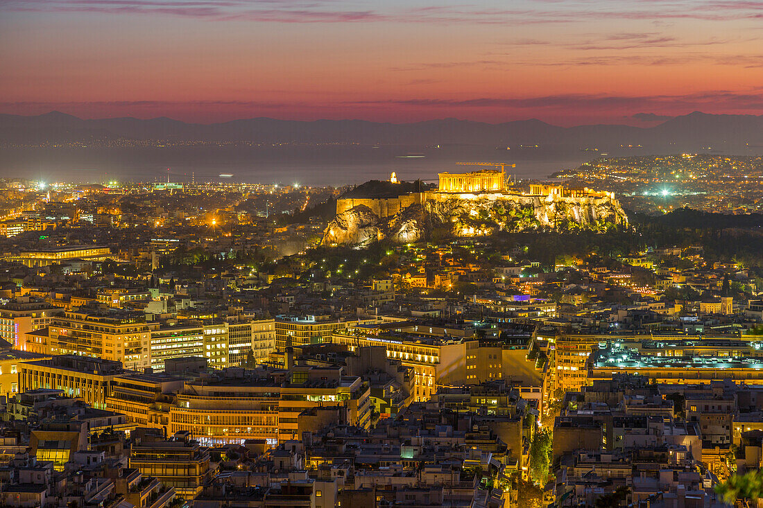 View of Athens and The Acropolis from Likavitos Hill with the Aegean Sea visible on horizon at dusk, Athens, Greece, Europe