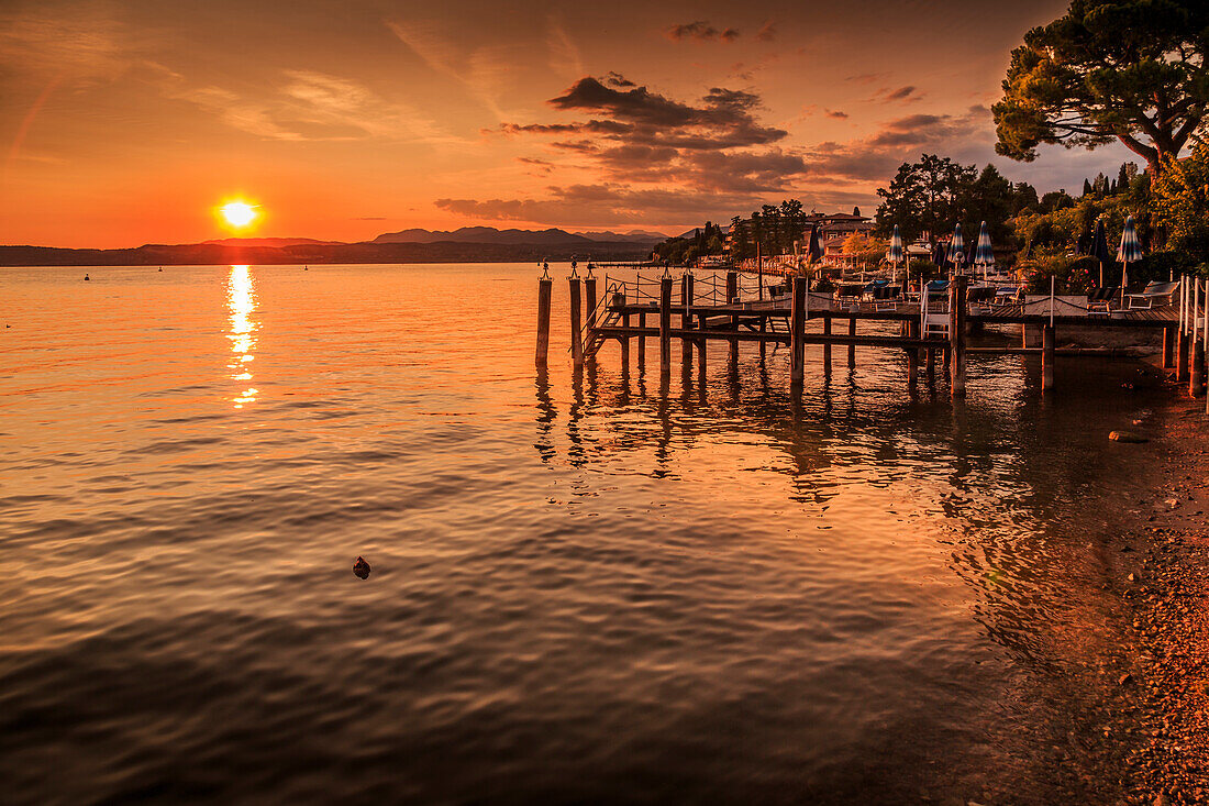 View of golden sunset on Lake Garda, Sirmione, Lake Garda, Lombardy, Italian Lakes, Italy, Europe