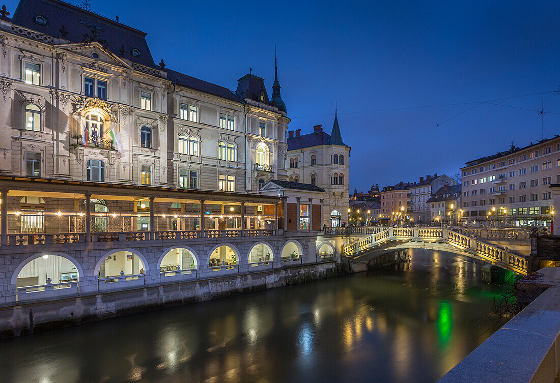 View of Triple Bidge across Ljubljanica River from Plaza Presernov at dusk, Ljubljana, Slovenia, Europe