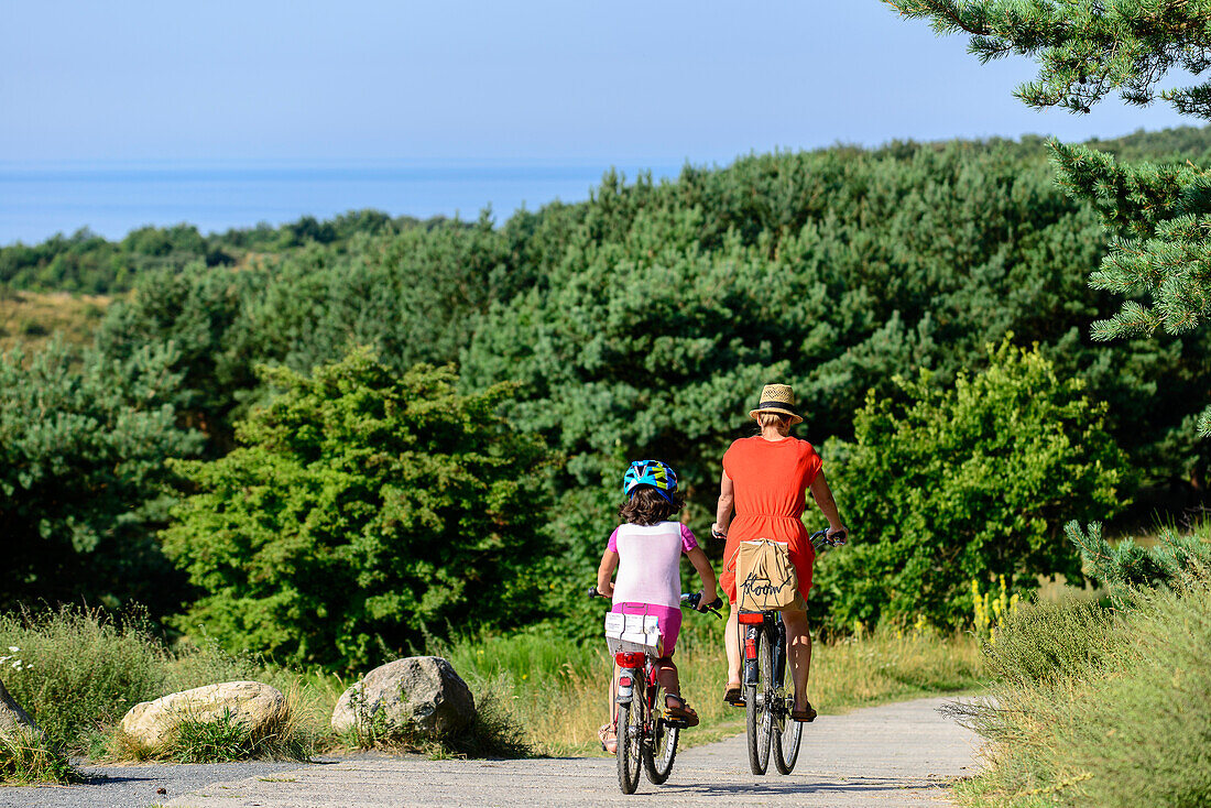 Mother with child cycle at Dornbusch, Hiddensee, Ruegen, Ostseekueste, Mecklenburg-Vorpommern, Germany