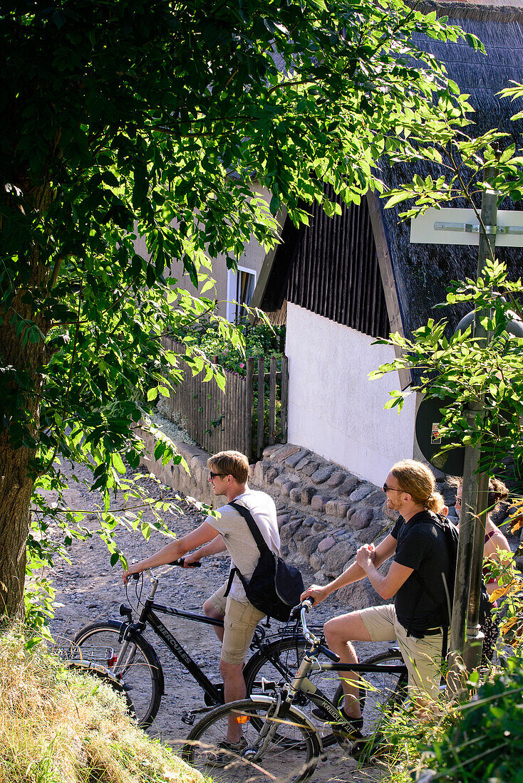 Cyclist in the fishing village Vitt, Ruegen, Baltic Sea coast, Mecklenburg-Vorpommern, Germany