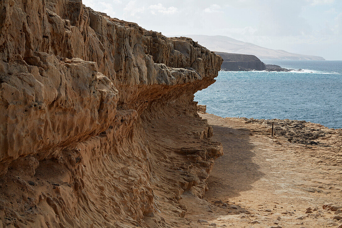 Walk along the cliff towards the Caleta Negra near Ajuy, Fuerteventura, Canary Islands, Islas Canarias, Atlantic Ocean, Spain, Europe