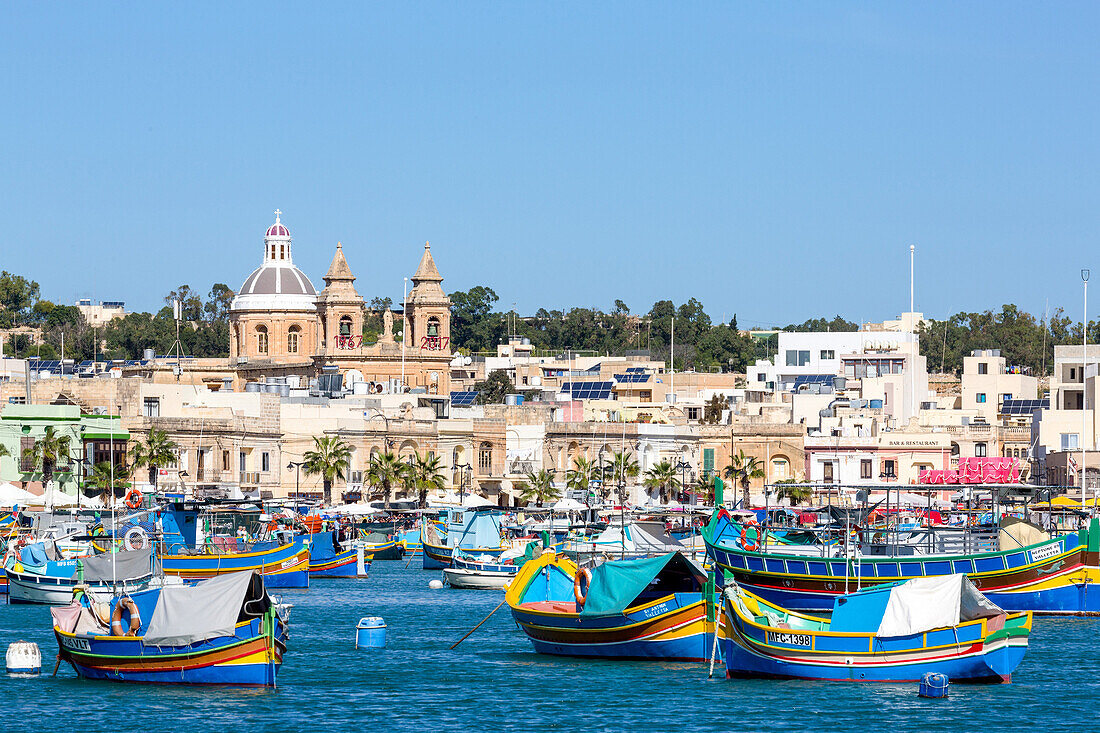 Traditional brightly painted fishing boats in the harbour at Marsaxlokk, Malta, Mediterranean, Europe