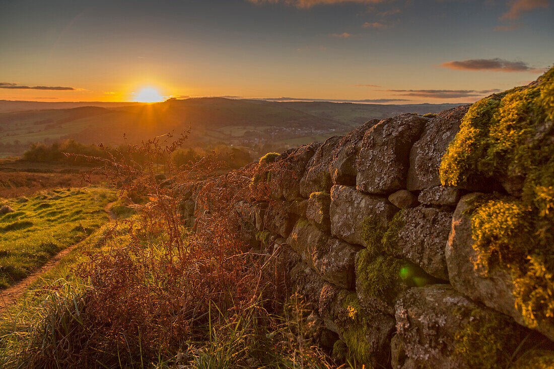 View of sunset from dry stone wall on Baslow Edge, Baslow, Peak District National Park, Derbyshire, England, United Kingdom, Europe