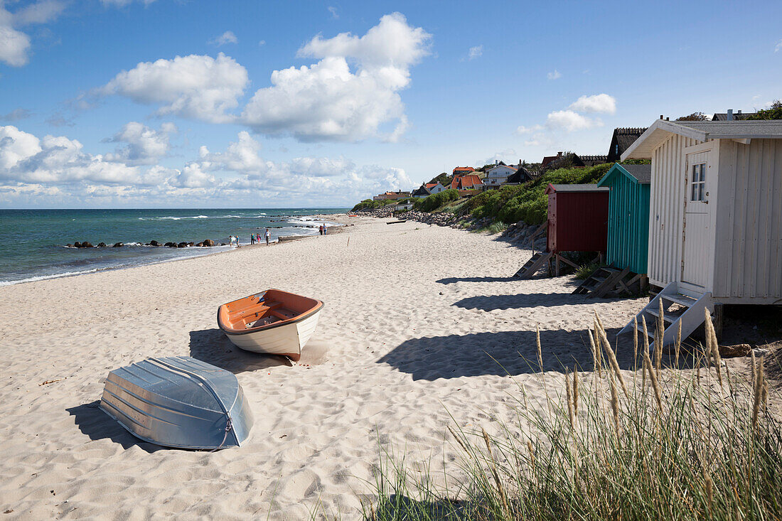 Boats and beach huts on white sand beach with town behind, Tisvilde, Kattegat Coast, Zealand, Denmark, Scandinavia, Europe