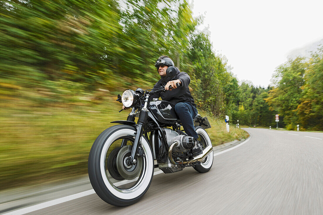 older man riding his motorbike