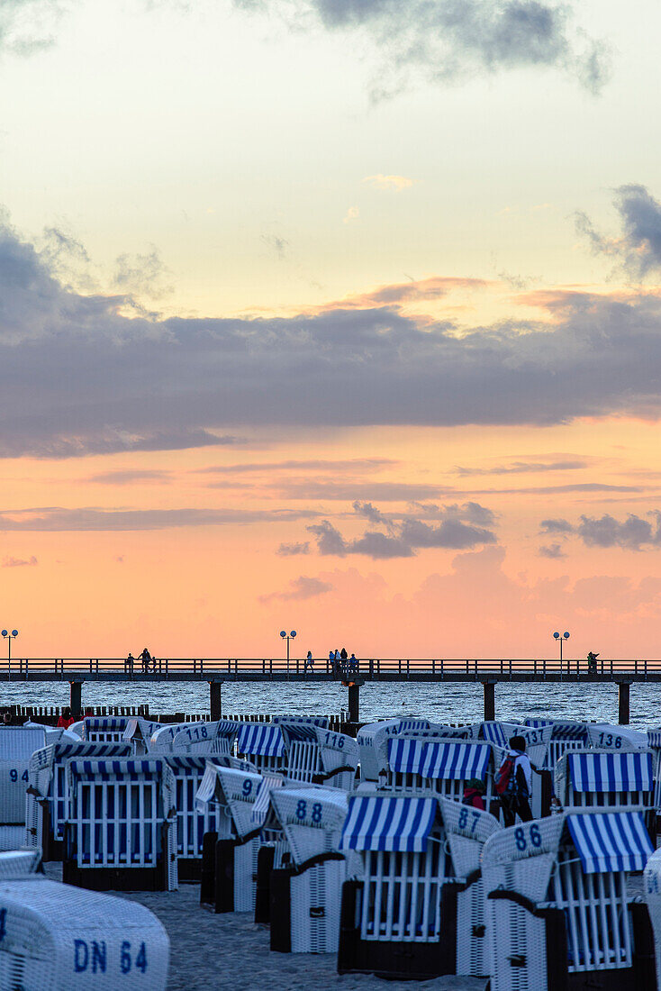 Pier with beach chairs and sunset, Ostseeküste, Mecklenburg-Western Pomerania, Germany