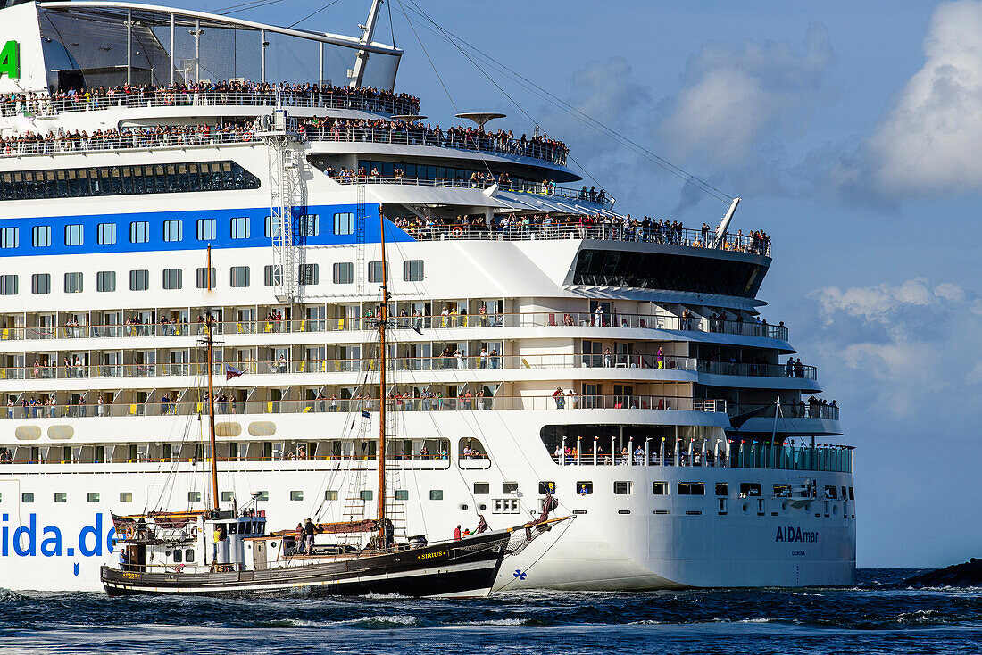 Two-masted schooner in front of huge cruise ship Aida, Warnemünde, Rostock, Baltic Sea coast, Mecklenburg-Vorpommern, Germany