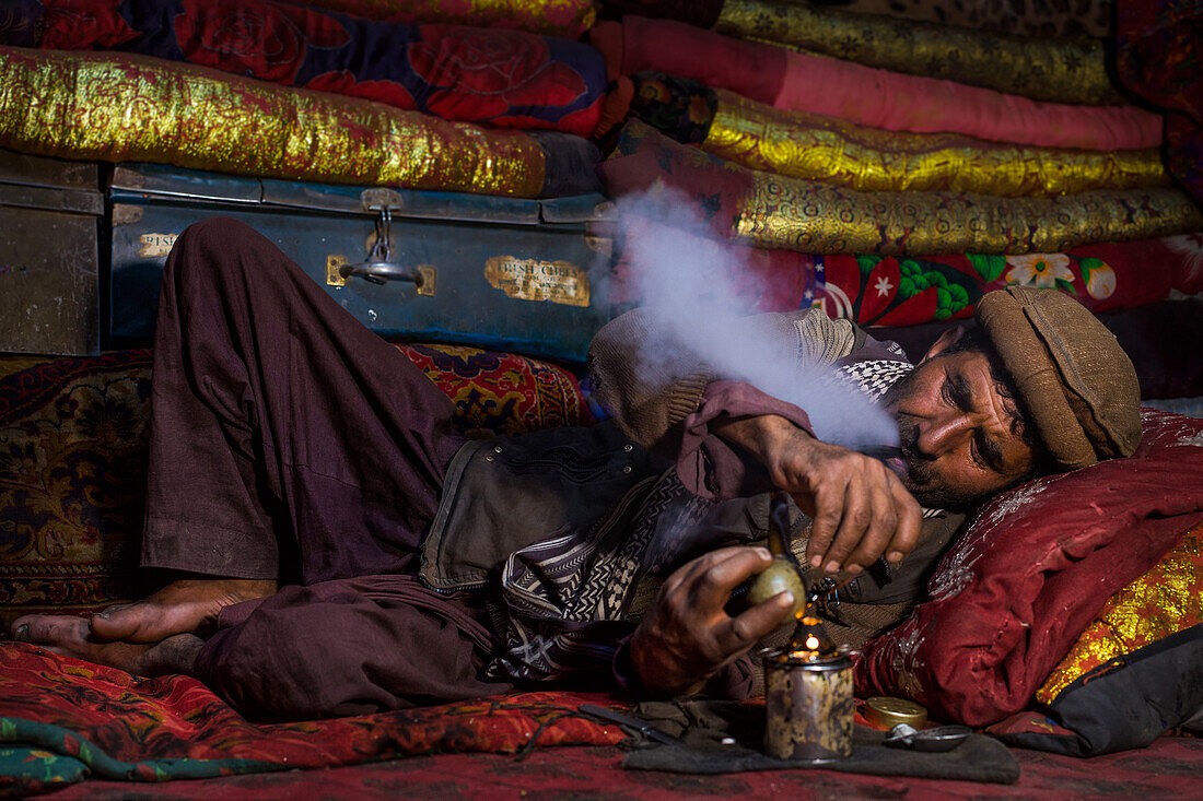 Afghan man smokes opium, Wakhan, Pamir, Afghanistan, Asia