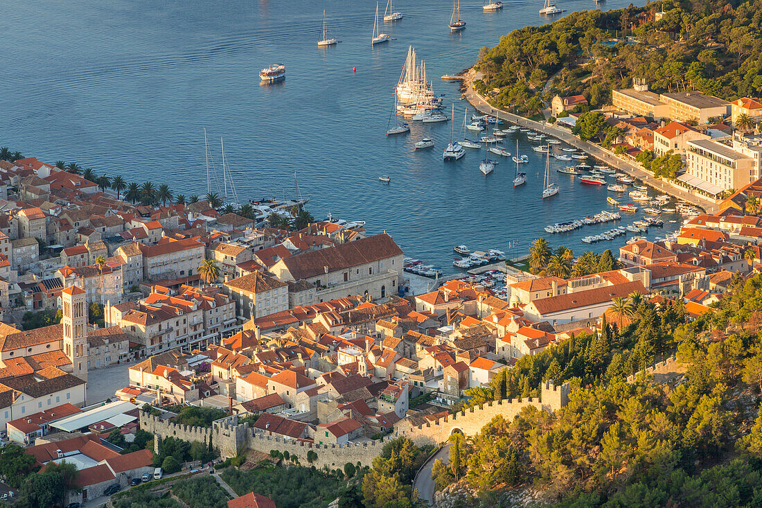 High-angle view over the port and the old town of Hvar Town at sunrise, Hvar, Croatia, Europe