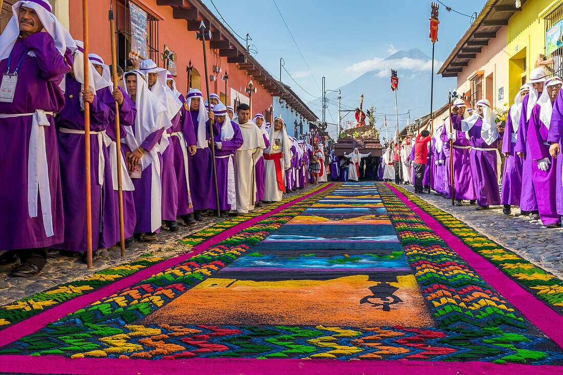 Good Friday procession approaching a sawdust carpet during Holy Week 2017 in Antigua, Guatemala, Central America