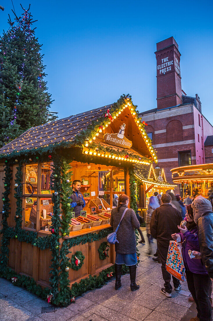 View of visitors and Christmas Market stalls at Christmas Market, Millennium Square, Leeds, Yorkshire, England, United Kingdom, Europe
