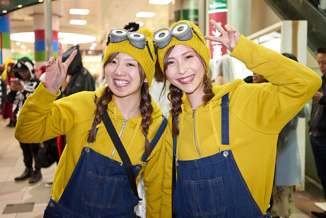Young Japanese girls dressed as Minions at the Halloween celebrations in Shibuya, Tokyo, Japan, Asia