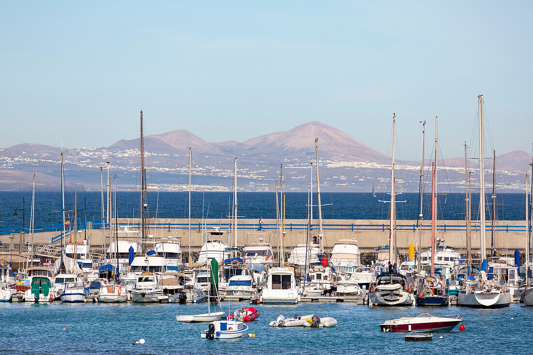 The harbour at Corralejo on the island of Fuerteventura with Lanzarote in the distance, Fuerteventura, Canary Islands, Spain, Atlantic, Europe