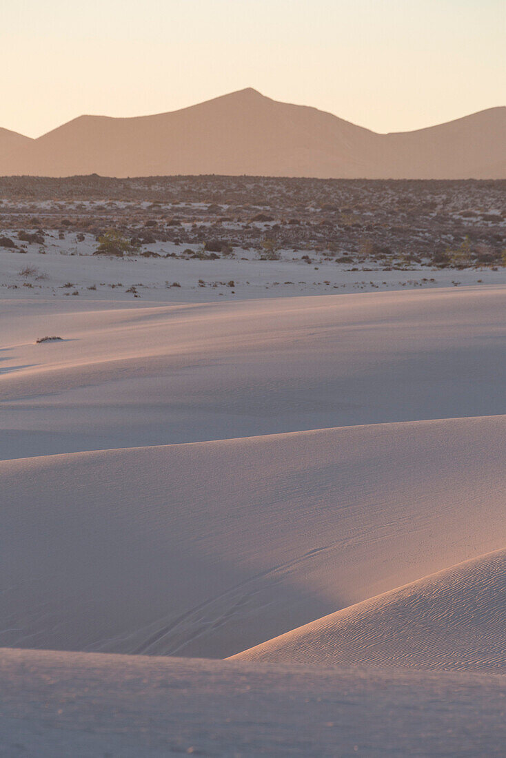 The dramatic Dunas de Corralejo in evening light on the volcanic island of Fuerteventura with mountains beyond, Fuerteventurra, Canary Islands, Spain, Europe