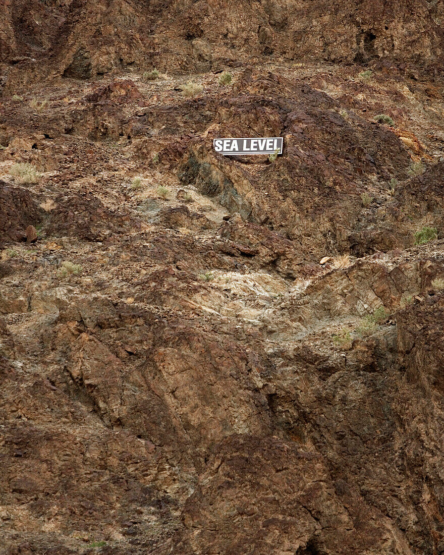 Sea Level sign on the side of a mountain. Bad Water Basin. Death Valley National Park, California.