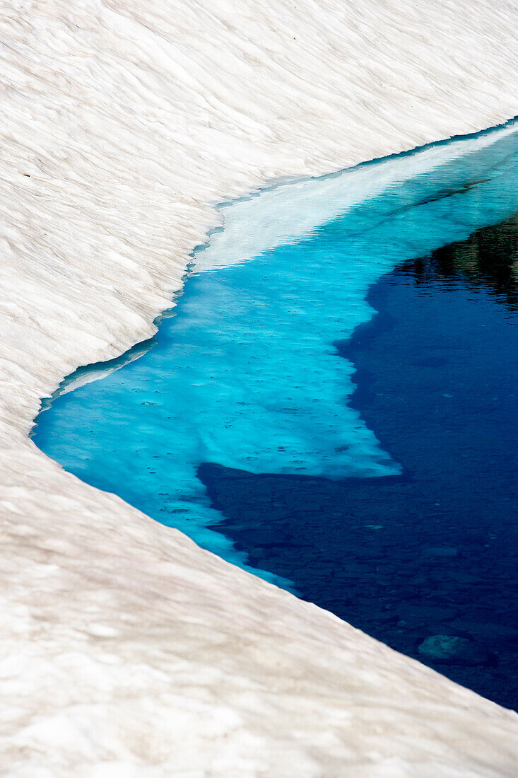 Snow on the banks of Lake Helen, Lassen National Park, California.