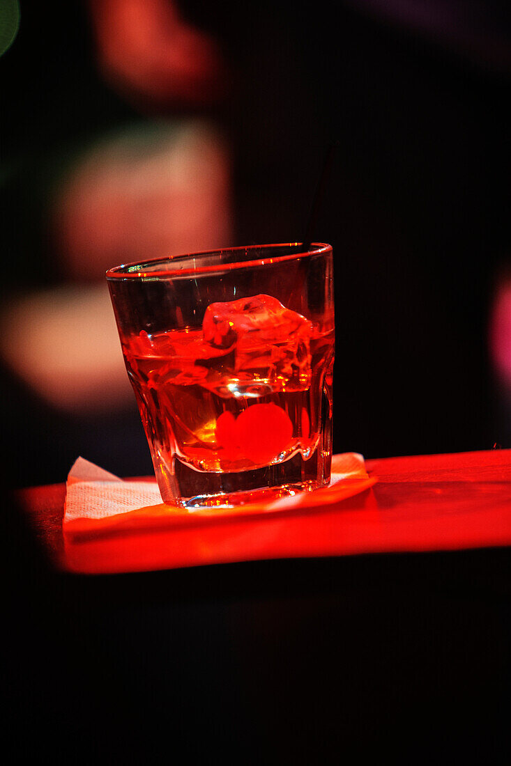 Close up of an alcoholic drink on a table. Soft focus.