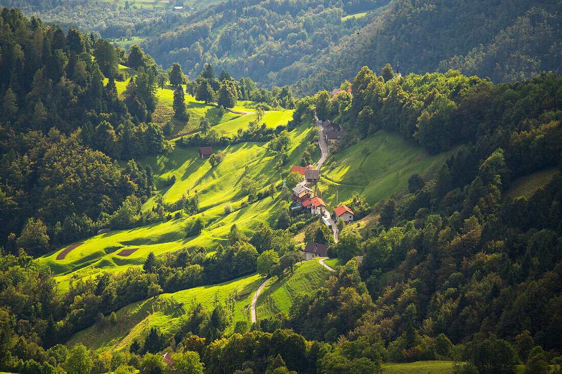 A Slovenian mountain village bathing in the sunlight. As seen from the Krn mountain in Triglav National Park, which is famous for the beautiful landscapes and nature.