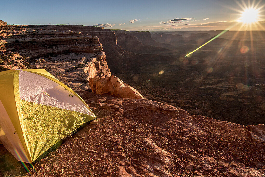 Yellow tent on mountain during scenic sunrise, Valley of Gods, Utah, USA