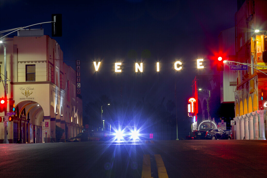 Famous Venice Beach sign lit up at night, Los Angeles, California, USA