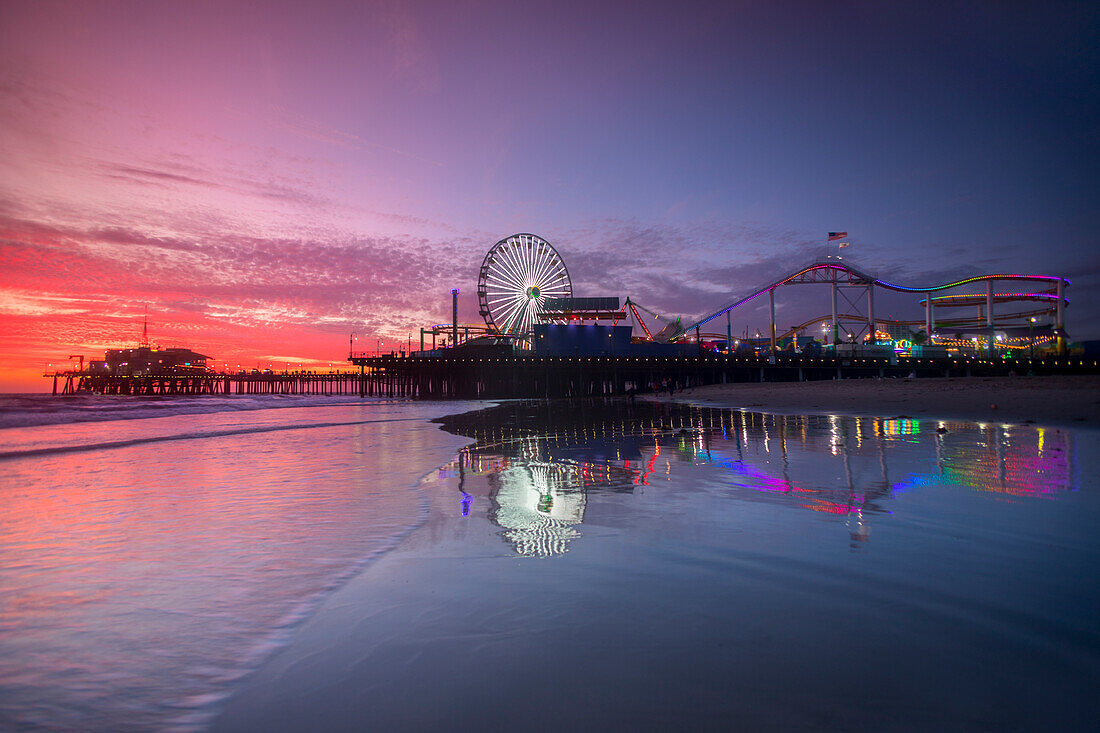 Amusement park and Santa Monica Pier at sunset, Los Angeles, California, USA