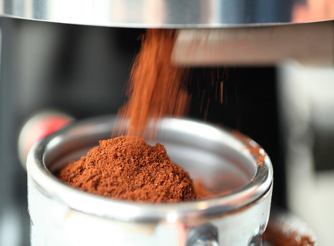 Pouring ground coffee, Oakland, California, USA