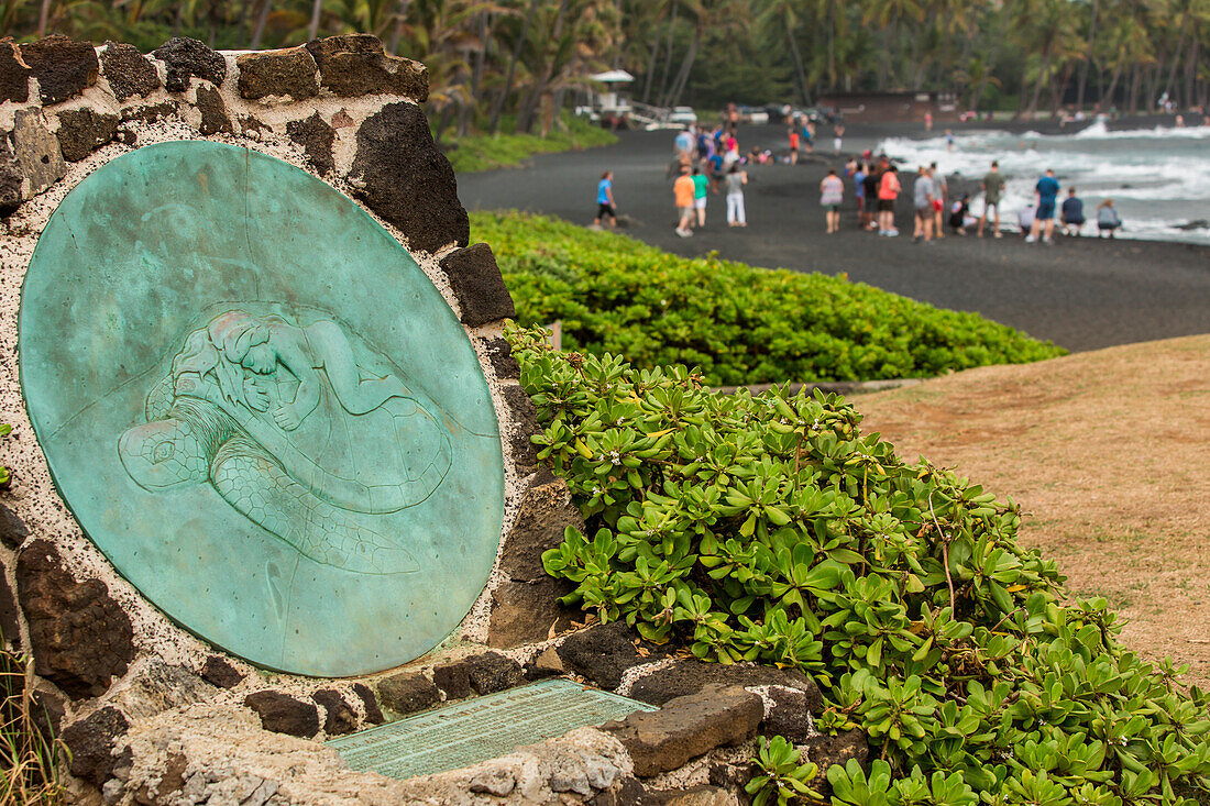 A statue commemorating the legend of Kauila and the sea turtles of Punaluu is at the entrance to Punaluu Black Sand Beach Park