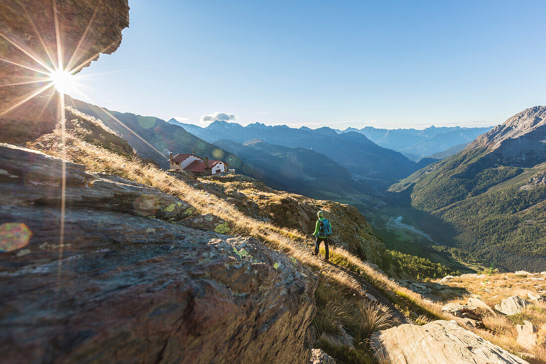 Hiker on path towards Rifugio Longoni, Chiesa in Valmalenco, Malenco Valley, province of Sondrio, Valtellina, Lombardy, Italy