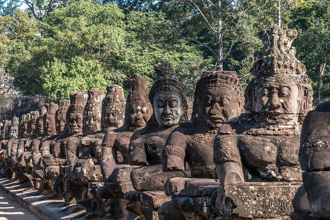 Detail of the stone faces on the bridge at the south gate of Angkor Thom, Angkor Temples complex, Cambodia, Asia