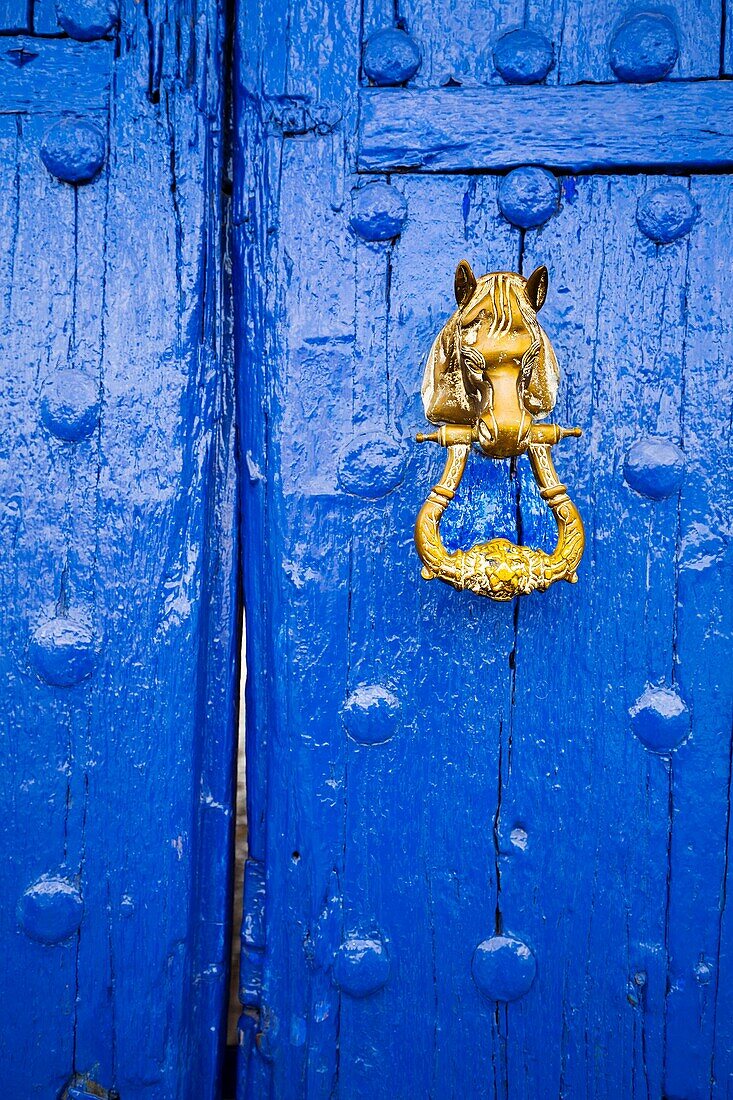 Blue entrance door and door knocker. Venta del Quijote. Puerto Lapice, Ciudad Real province, Castilla La Mancha, Spain Europe.