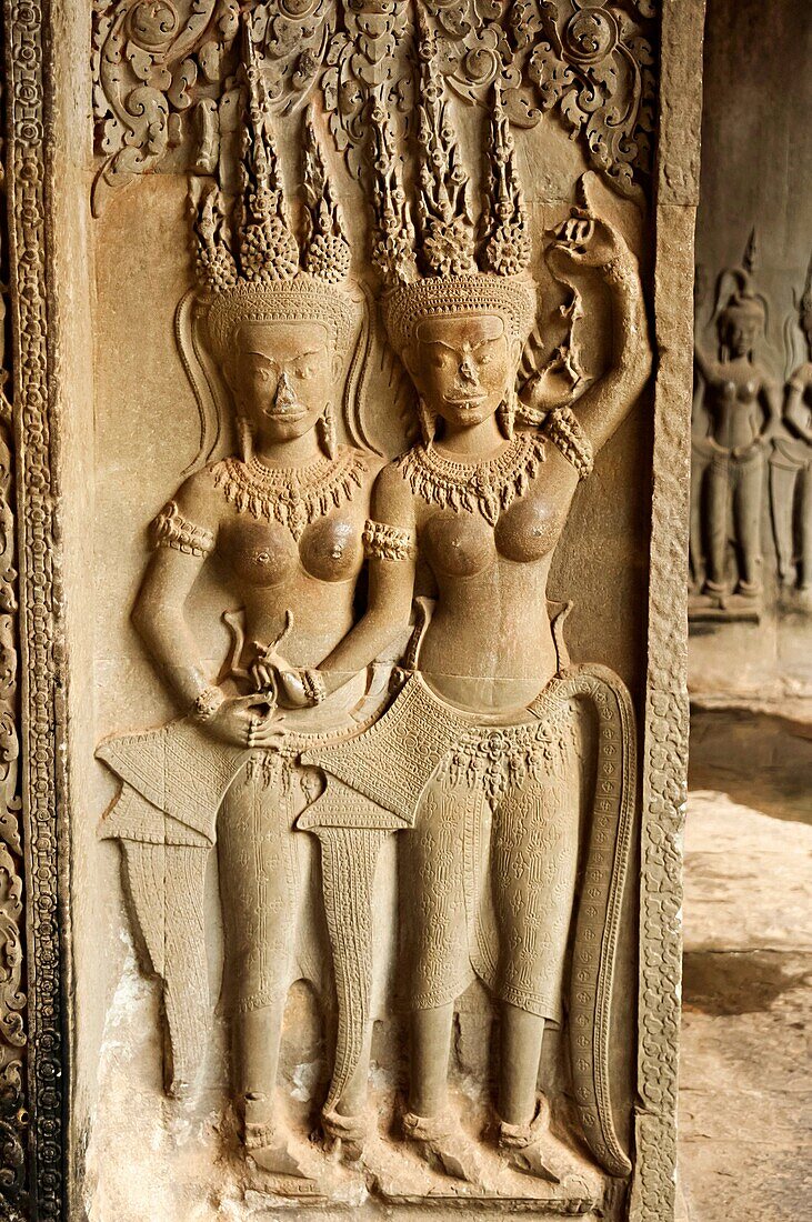 Sculpture of apsaras and carved pillar. Angkor Wat, Siem Reap, Cambodia. Largest religious monument in the world 162. 6 hectares. UNESCO World Heritage.