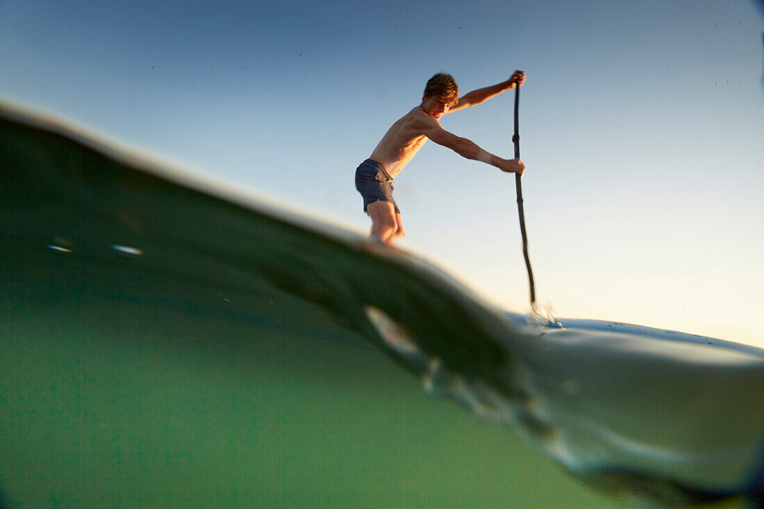 Young Stand Up Paddler on Lake Starnberg,  Lake Starnberg, Bavaria, Germany