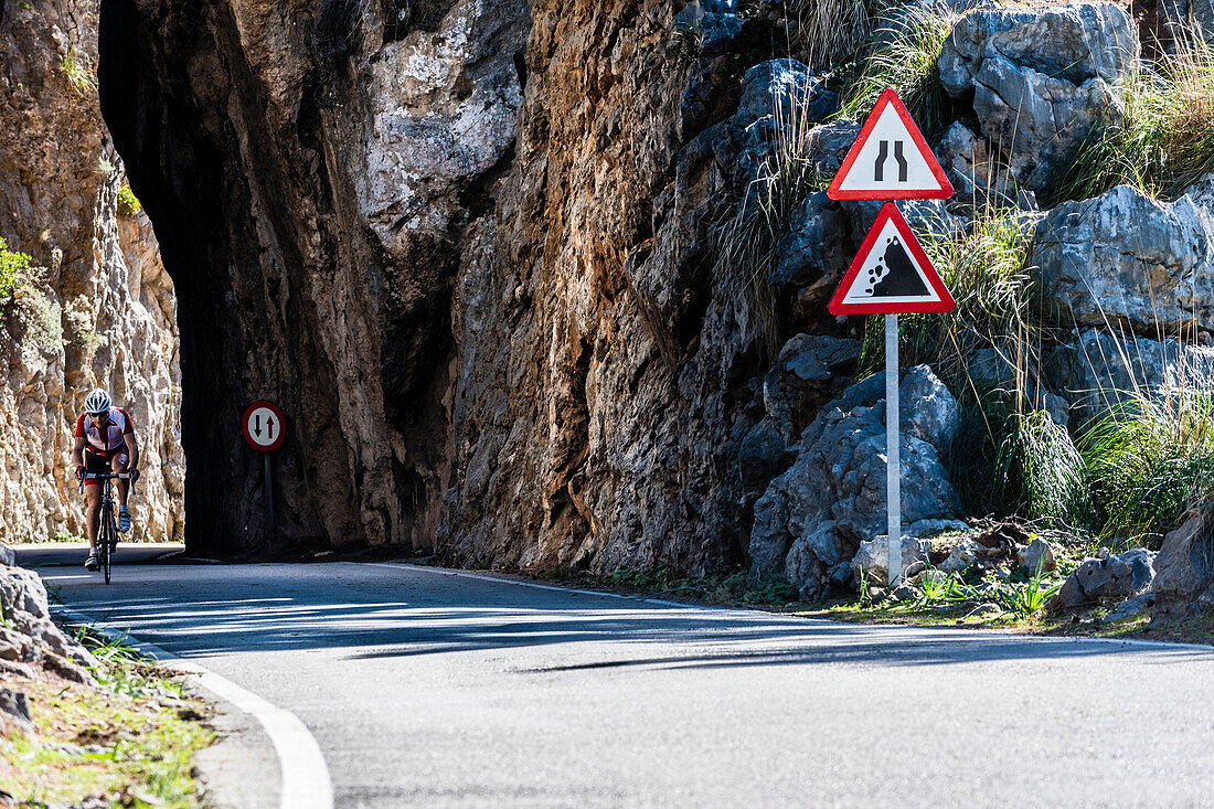 A cyclist on the famous winding road leading to Torrent de Pareis, Sa Calobra, Tramuntana Mountains, Mallorca, Spain