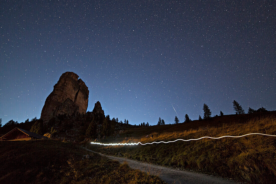 Light trail during a starry night on Cinque Torri, Dolomites, Cortina d'Ampezzo, Belluno province, Veneto, Italy